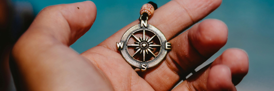 A compass on an old map showing multiple directions